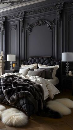 a large bed in a bedroom with black walls and white fur on the headboard