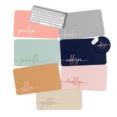 four different colored mousepads with the names of their respective computers and keyboards in cursive writing