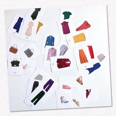 an assortment of clothes and shoes are displayed on a white surface with paper cut outs