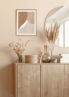 a wooden dresser topped with lots of vases and plants in front of a mirror