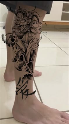 a woman's leg with tattoos on it