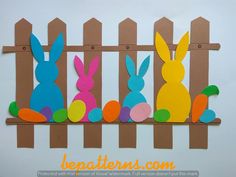 an easter card with paper cut out of bunnies and carrots on a fence