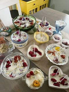 the table is covered with bowls and plates filled with desserts