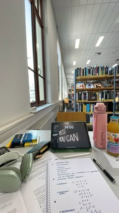 there are many books on the table in this library