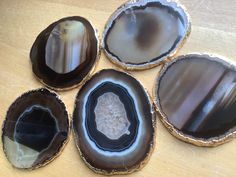 four different types of agate shells on a table with white and black speckles