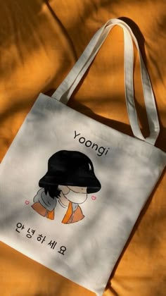 a tote bag with an image of a woman wearing a black hat on it