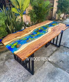 a bench made out of wood with blue and green paint on it's sides