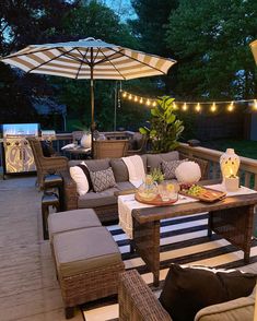 an outdoor patio with wicker furniture and lights