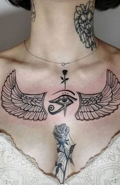 a woman's chest with tattoos on it and an all seeing eye tattoo design