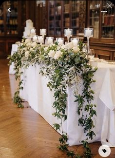 the table is set up with candles and greenery for an elegant wedding reception at st mary's church