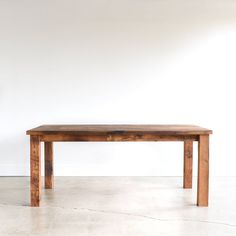 a wooden table sitting on top of a white floor