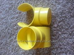 two yellow plastic cups sitting on top of a carpet