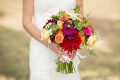 a woman holding a bouquet of flowers in her hands