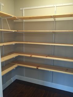 empty shelving unit with wood floors and white walls