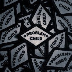 several patch badges with the words problem child on them, all in black and white