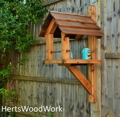 a bird house built into the side of a wooden fence