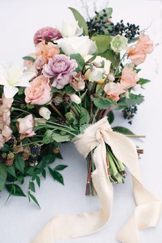 a bouquet of flowers is tied up on the table