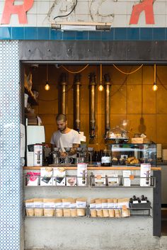 a man standing behind a counter in front of a store