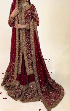 a woman in a red and gold bridal gown