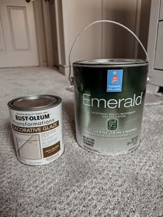 a can of paint next to an empty bucket