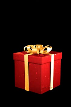 a red gift box with gold ribbon and a bow on it's side, against a black background