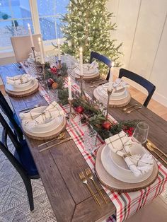 a dining room table set for christmas dinner