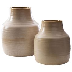 two vases sitting next to each other on a white background