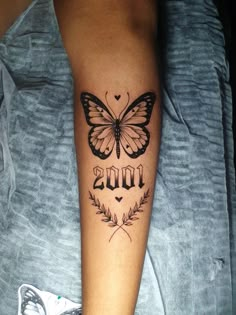 a butterfly with the word love tattooed on it's arm