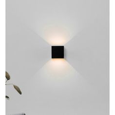 a square light fixture mounted on the wall in a room with white walls and flooring