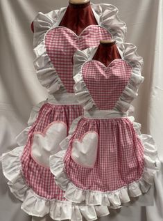 ** FABRIQUE CREATIONS ** MOTHER & DAUGHTER MATCHING SET VINTAGE / 50's STYLE FULL APRON / PINNY with HEART SHAPED TOP & POCKET PINK & WHITE GINGHAM with WHITE TRIM ONE SIZE (SEE DESCRIPTION) ** BRAND NEW ** Here we have a lovely and cute, set of 2 poly cotton pink and white gingham with white trim retro style aprons with heart shaped top and pocket, handmade in house to our own design. (see photos). Adjustable waist ties so will fit up to a size 22 on the adult version and a child up to age 7/8. THIS ITEM IS MADE TO ORDER - PLEASE ALLOW EXTRA TIME FOR POSTAGE Other colour combinations available (please see my other items!.) If you don't see what you require, please contact us with your requirements Item specifics: Material - Poly cotton Colour - Pink and white  Size (Approx) - one size Abo House Wife Outfits, 50s Apron, Heart Shaped Top, Pink Apron, Full Apron, 50's Style, Heart Pocket, Cute Aprons, 50s Style