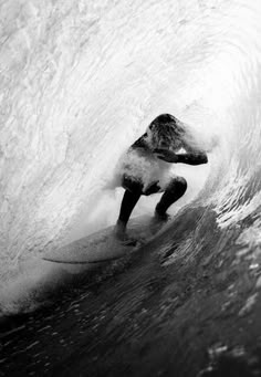 a man riding a wave on top of a surfboard