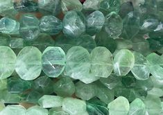 many green and white crystals are stacked on top of each other