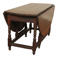 an old wooden table with two stools on the bottom and one at the top