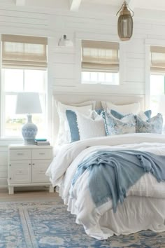 a bedroom with white walls and blue accents