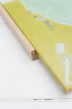 a close up of a piece of wood with paint on it and the edge of a board