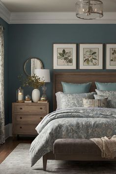 a bedroom with blue walls and furniture in the corner, including a bed that has pillows on it