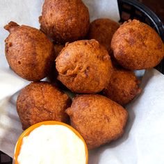 some food is sitting on top of a white napkin and next to an orange cup