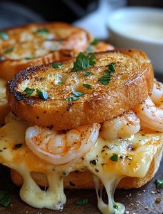 grilled cheese and shrimp sandwich on toasted bread with melted cheese drizzled over it