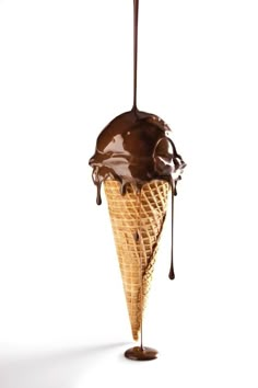 an ice cream cone with chocolate sauce drizzled on it's side