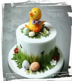 a decorated cake with an easter duck on top