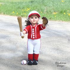 a crocheted doll holding a baseball glove and ball in its hand on a dirt road