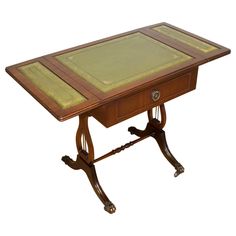 a small wooden table with a green cloth on top