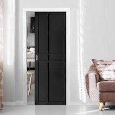 a living room filled with furniture and a tall black cabinet