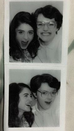 black and white photo of two women with glasses on their faces, one smiling at the camera