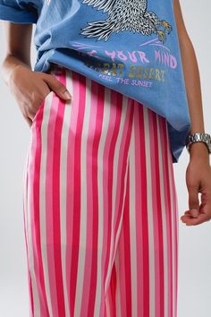 Elevate your wardrobe with these sophisticated Vertical Striped Satin Pants, featuring a chic pink hue with vertical stripes in blue and white. Perfect for adding a touch of elegance to your ensemble, these pants are designed for both style and comfort.  Crafted from luxurious satin fabric, these pants offer a smooth and lustrous feel that drapes beautifully. The high waist rise and straight leg silhouette create a flattering look that elongates the legs for a sleek and stylish appearance.  Featuring a side zipper closure and side pockets, these pants combine practicality with fashion-forward design. Whether you're attending a party or enjoying a night out, these pants are sure to make a statement.  Our model, standing at 5'9'' with measurements of 33-24-35, is wearing a size S. For your c Model Standing, Striped Pant, Satin Pants, Skirt Jumpsuit, Scarf Headband, Chic Pink, Vertical Stripes, Romper Pants, Straight Pants