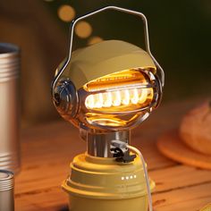 a yellow light sitting on top of a wooden table