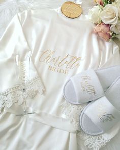 the bride's robe and slippers are laid out next to their wedding shoes