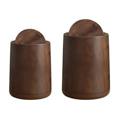 two wooden salt and pepper shakers are shown in this image, one is brown