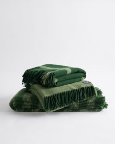 three green towels stacked on top of each other