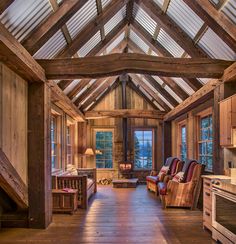 an open living room with wood floors and vaulted ceiling